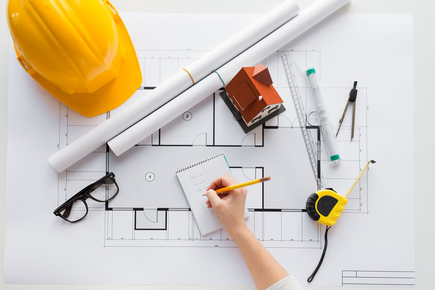 close up of architect hand with blueprint